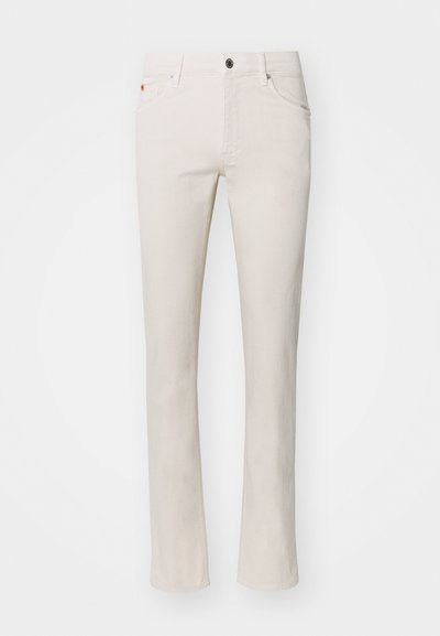 Beige straight-leg jeans made from cotton blend fabric. Features traditional five-pocket design and metal button closure at waistband.