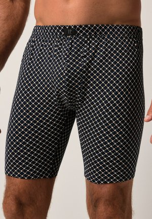 Bóxer en color navy con un patrón de rombos en crema, fabricado en tejido elástico con una cinturilla elástica para mayor comodidad.