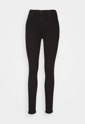 Jean skinny noir taille haute avec fermeture par bouton et zip, poches avant et arrière, présenté sur fond blanc.