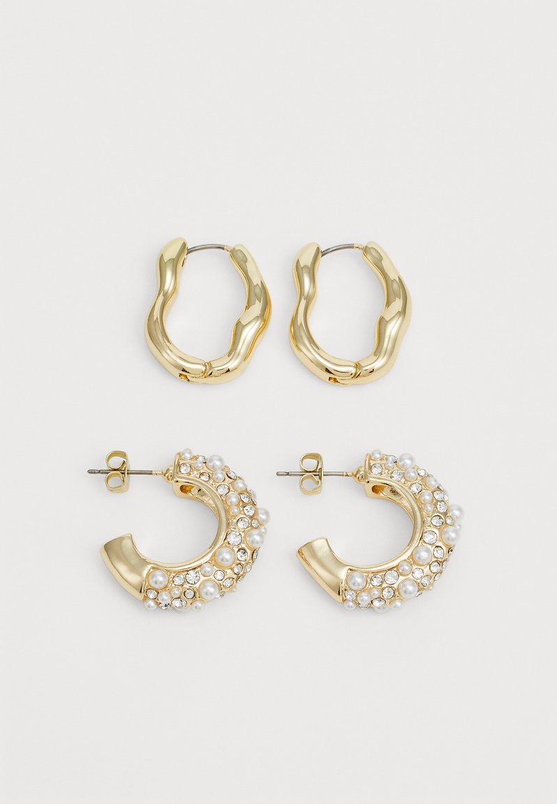 Two pairs of gold-tone hoop earrings. One pair features a smooth, wavy design; the other is adorned with pearls and rhinestones.