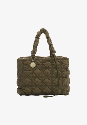 Quilted olive green tote bag with dual handles. Features diamond patterns, a decorative charm, and a slim adjustable strap.