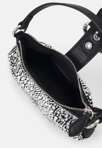 Black handbag with silver rhinestones, zip closure, fabric lining, and a leather strap. Features various crystal patterns on the exterior.