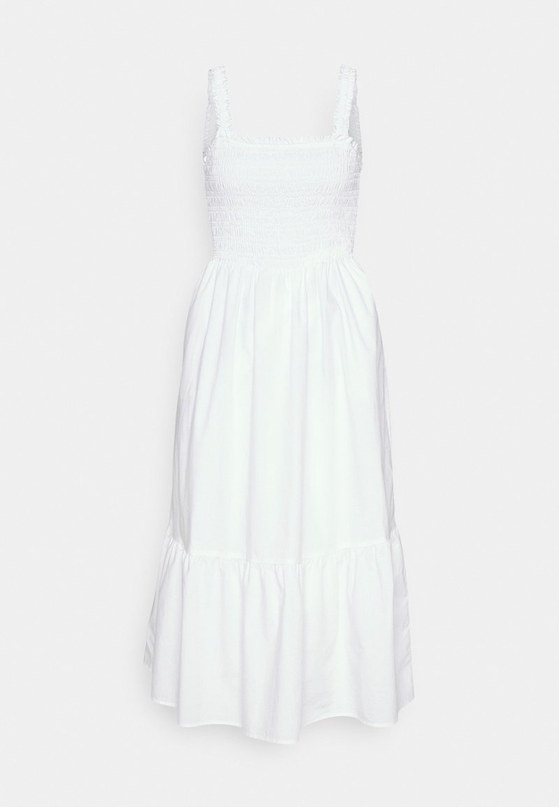Robe midi blanche sans manches avec un corsage smocké, un décolleté carré, des bretelles à volants et un ourlet à volants froncés.