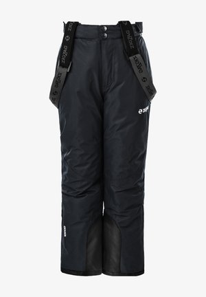 Enfant portant une combinaison de neige imperméable noire avec des accents verts vifs et gris, dotée d'une capuche et de poches zippées, associée à des bottes noires.