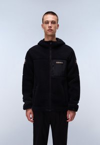 Black fleece hoodie with a front zipper, kangaroo pockets, and a chest pocket with black fabric. Features a subtle logo and textured design.