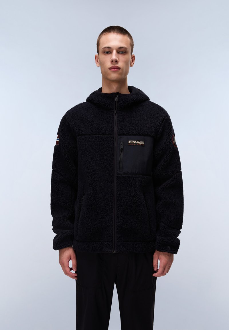 Black fleece hoodie with a front zipper, kangaroo pockets, and a chest pocket with black fabric. Features a subtle logo and textured design.