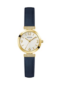 Montre-bracelet dorée avec un cadran blanc rond, un bracelet en cuir bleu marine, et des accents décoratifs en cristal près des cornes. Chiffres arabes aux positions 3, 6, 9 et 12.