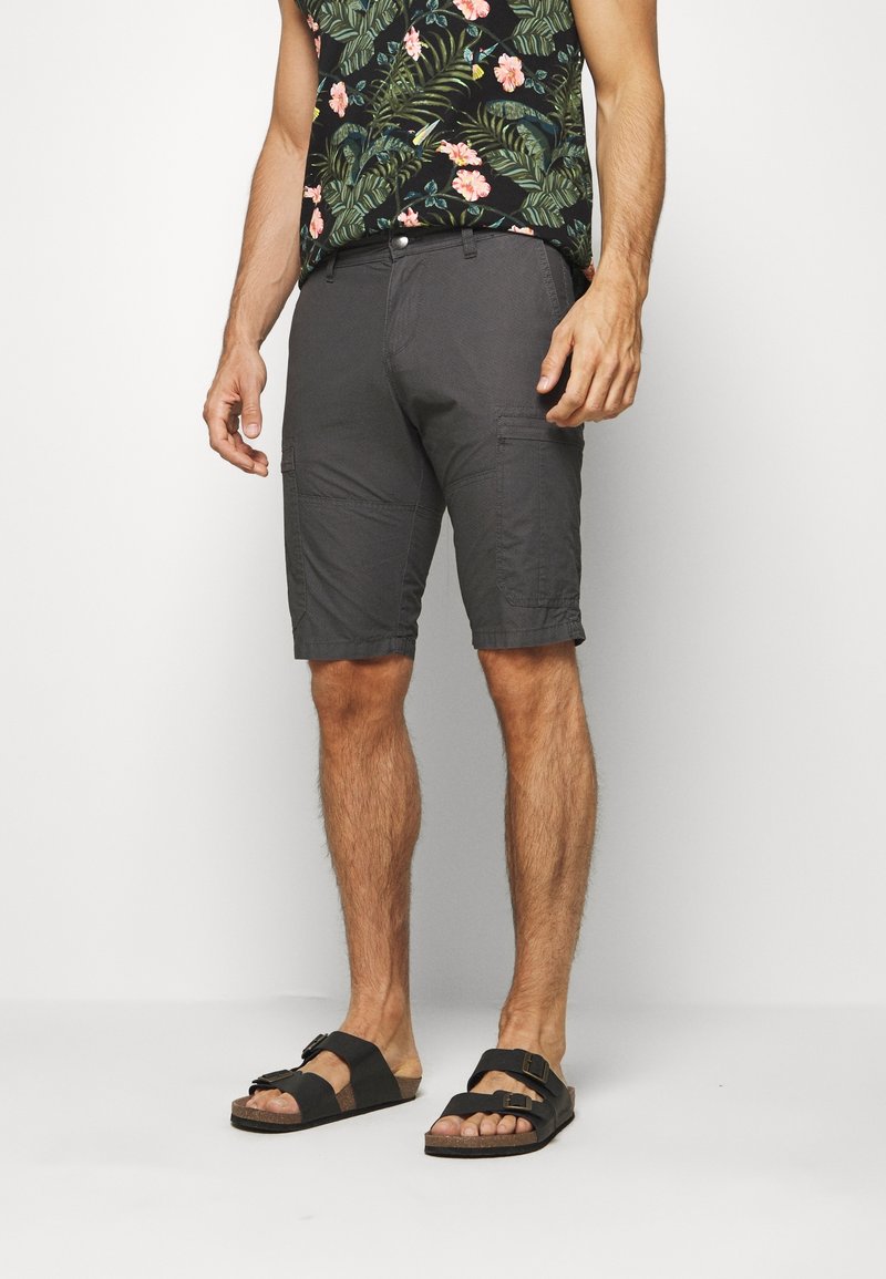 Shorts de carga grises con un acabado texturizado, que cuentan con múltiples bolsillos y un corte relajado, combinados con sandalias negras.