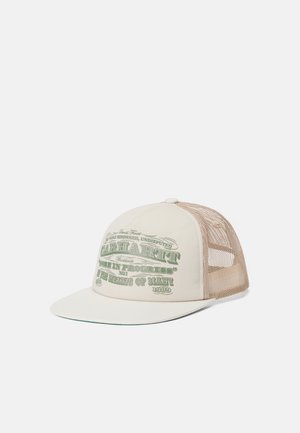 Cream baseball cap with a stiff brim and mesh back, featuring green printed text and graphic designs on the front panel.
