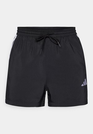 Fekete sportnadrág, elasztikus derékkal, zsinórral, fehér oldalsávokkal. A bal alsó lábszáron egy kis szürke logó található.