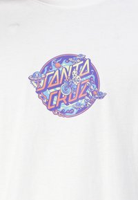 White t-shirt featuring a circular graphic design with "Santa Cruz" text, alien and skateboard images, and colorful, swirling patterns.