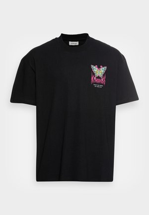 Black short-sleeve T-shirt with a colorful butterfly graphic and text "Trust the timing of your life" on the upper left chest.