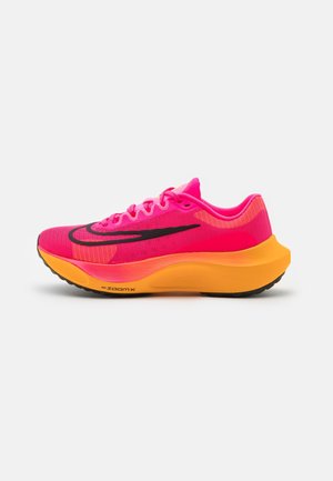 Bright pink and orange running shoe with black swoosh logo and thick cushioned sole on a white background.