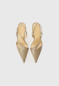 Pointed-toe slingback shoes in taupe leather with a single strap. Smooth texture and minimalistic design with a narrow heel.