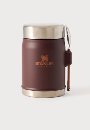 Pot isotherme marron Stanley pour aliments, avec un couvercle et un fond en acier inoxydable, une poignée latérale et une dragonne de transport attachée.