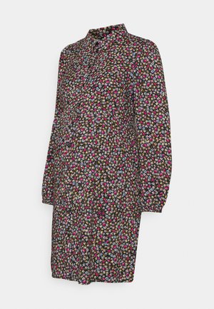 Vestido preto com padrões florais, apresentando um colarinho, mangas longas e um corte solto. O padrão inclui flores multicoloridas sobre um fundo preto.