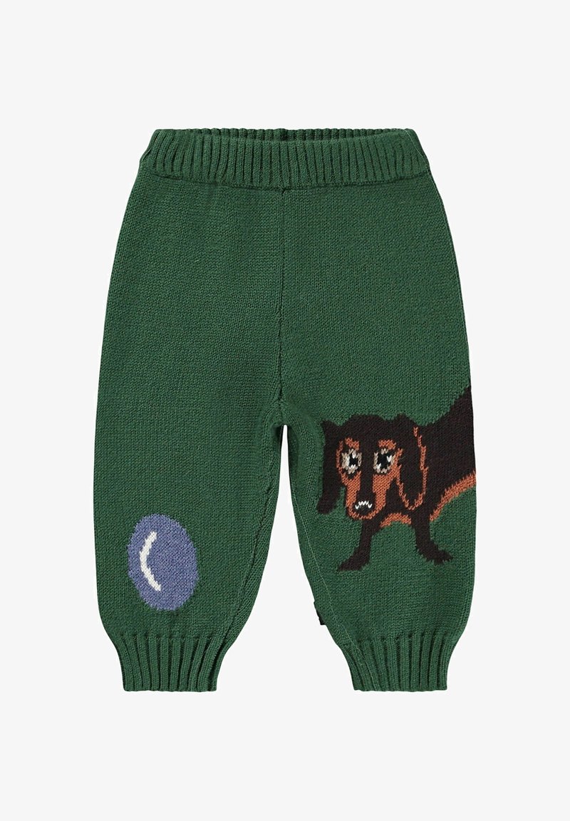 Zielone, dziane spodnie dziecięce z prążkowanym paskiem w talii, z wzorem przedstawiającym jamnika oraz niebieską piłką po boku.