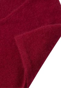 Bordowy materiał wełniany o miękkiej, teksturowanej powierzchni, układający się w sposób elegancki, aby podkreślić swoje ciepło i bogaty kolor. Lekko puszysty wygląd.