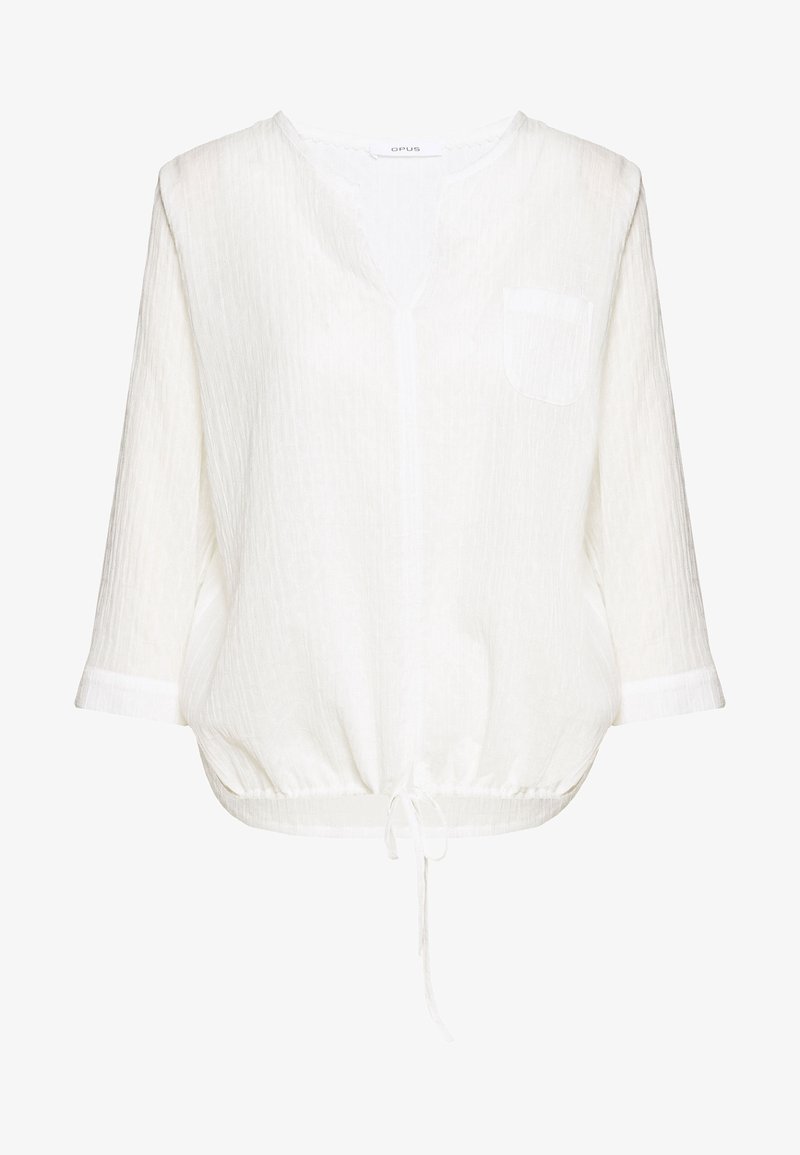 Blouse blanche à manches longues avec col en V, poche poitrine, coupe ample, tissu texturé et cordon réglable à l'ourlet.