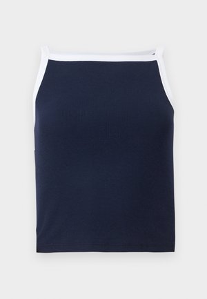 Marineblå ribbeformet tanktop med hvit kant, med rund hals og smale stropper. Laget av en myk bomullsmiks for komfort.