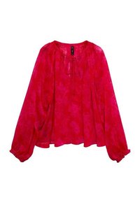 Blouse rouge à manches longues avec motif floral, coupe ample, poignets froncés et un lien à l'encolure ronde.