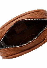 Borsa a tracolla in pelle marrone con superficie texturizzata, chiusura con zip e scomparti interni. L'interno è in tessuto scuro e presenta un'etichetta.