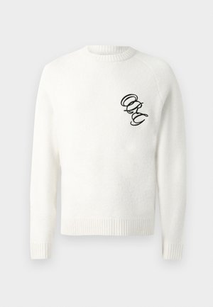 Suéter blanco de tela suave, con un cuello y puños de canalé. Letras negras bordadas "ORG" en el área izquierda del pecho.