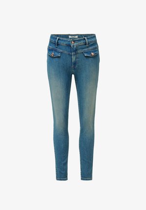 Jean skinny en denim bleu moyen avec des zones décolorées. Comprend deux poches avant, deux poches arrière et des garnitures couleur cuivre.