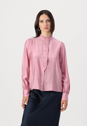 Pink button-up blouse with a ruffled collar and cuffs. Features long sleeves, smooth texture, and a slightly loose fit.