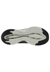 Suola di scarpa con un'intersuola bianca flessibile e una suola in gomma nera testurizzata. Motivi scanalati per trazione e grip.