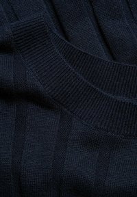 Granatowy sweter dzianinowy z pionowym prążkowanym teksturą i okrągłym kołnierzem. Miękki materiał o grubym, przytulnym wyglądzie.