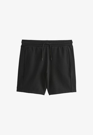 Fekete sport rövidnadrág puha anyagból, elasztikus derékrésszel, húzózsinórral és két oldalsó zsebbel. Sima textúra, laza dizájn.