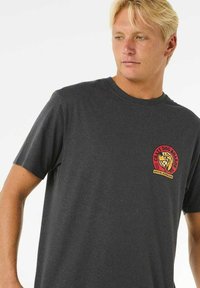Dark gray short-sleeve T-shirt made of cotton, featuring a round neckline and a colorful graphic logo on the left chest.