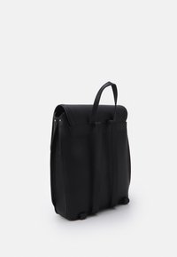 Zaino in pelle nera con finitura testurizzata, parte superiore arrotolata, due tracolle rettangolari e piedi rotondi per maggiore stabilità.