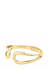 Bracciale in metallo color oro con un design fluido e a spirale, caratterizzato da una superficie liscia. Branding sottile su un dettaglio decorativo.