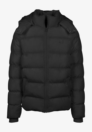 Crna puffer jakna s visokim ovratom, horizontalnim quilted dizajnom, prednjim patent zatvaračem i detaljima na dugmadi. Ima bočne džepove.