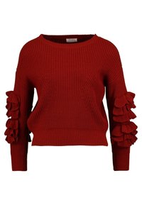 Punainen neulottu neulepusero pyöreällä pääntiellä, jossa on röyhelökoristeet hihoissa ja lyhyt malli. Pinta on teksturoitu ja siinä on ribbikoristelu.