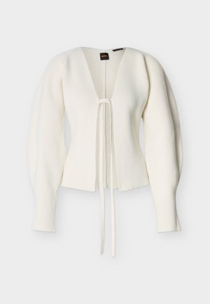 White ribbed knit cardigan with puffed long sleeves, deep V-neck, and front tie closure, displayed on a plain background.