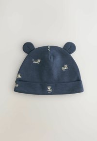 Tumši zils kokvilnas cepure ar lāča ausīm, ar mazu balto tīģeru rakstu. Salocīts apmales malas un gluda tekstūra.