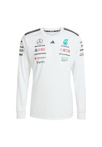 Camisa blanca de manga larga con acentos negros. Presenta logotipos de Mercedes, Petronas y TeamViewer. Diseño de cuello en V, confeccionada con tela suave.