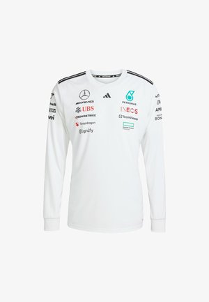 Langärmliges weißes Hemd mit schwarzen Akzenten. Enthält Logos wie Mercedes, Petronas und TeamViewer. V-Ausschnitt, aus glattem Stoff gefertigt.