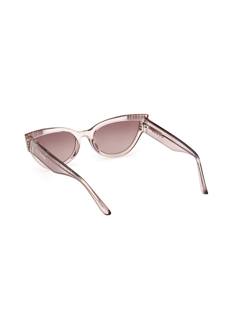 Cat-Eye-Sonnenbrillen aus transparentem, hellrosa Kunststoff mit verlaufenden braunen Gläsern und gravierten Akzenten an den Bügeln.