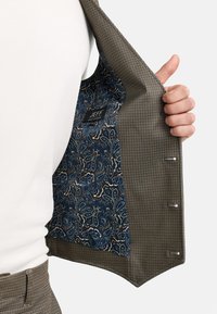 Braun kariertes Blazer mit einem blauen Paisley-Innenfutter. Verfügt über ein Etikett und silberfarbene Knöpfe im Frontverschluss.