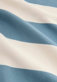 Cotton fabric featuring alternating horizontal stripes in light blue and cream, with a smooth texture and soft appearance.