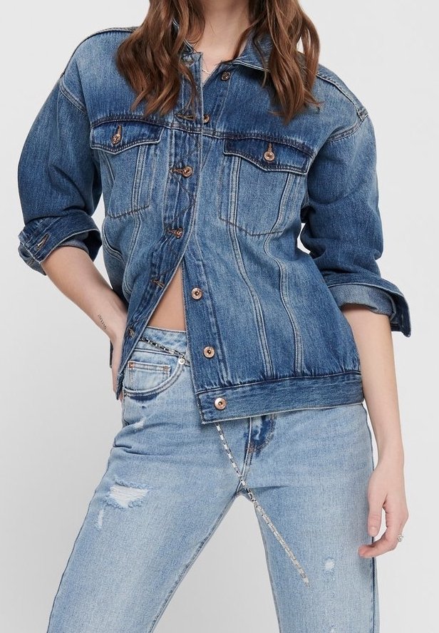 Denim jacket in a medium blue wash with a button-up front, chest pockets, and rolled cuffs. Paired with light blue distressed jeans.