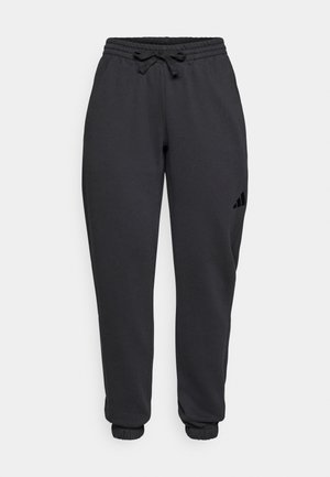 Pantalones de chándal negros confeccionados en tejido suave, con una cinturilla elástica y cordón, puños acanalados y un pequeño detalle de logo en el lateral.