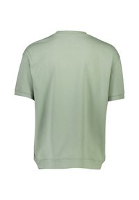 Jasnozielona bawełniana koszulka z krótkim rękawem, okrągłym dekoltem i luźnym krojem. Gładka tekstura o prostym, czystym wzorze.