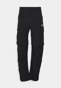 Pantalons de randonnée noirs convertibles avec jambes amovibles, poches latérales zippées et logo The North Face sur la cuisse droite.