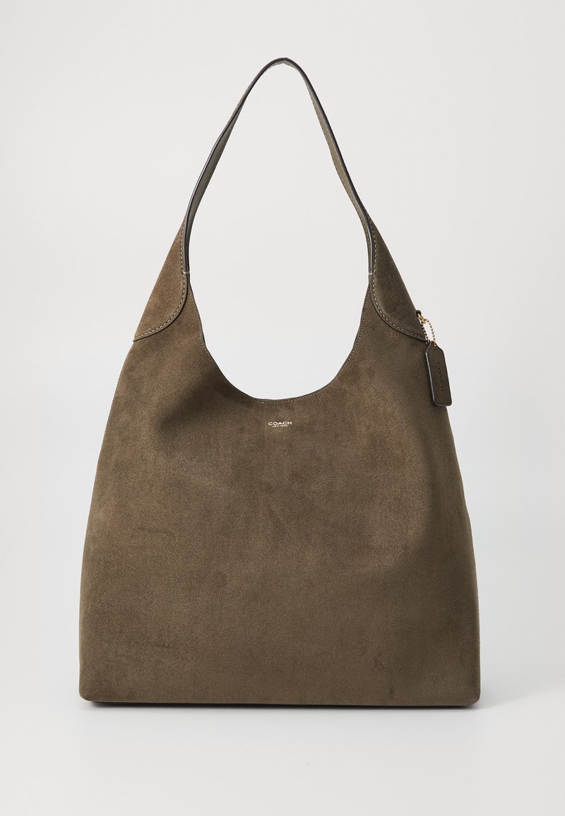 Brown suede shoulder bag with a rounded shape, single shoulder strap, and minimal hardware detail, featuring an embossed logo on the front.