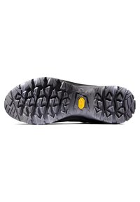 Semelle extérieure Vibram avec un motif de crampons multidirectionnel pour l'adhérence, en caoutchouc gris avec un logo jaune et un talon renforcé.
